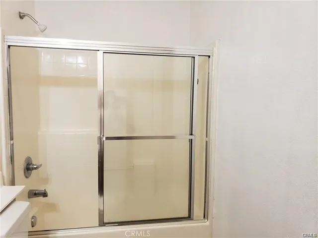 a bathroom with a glass shower door