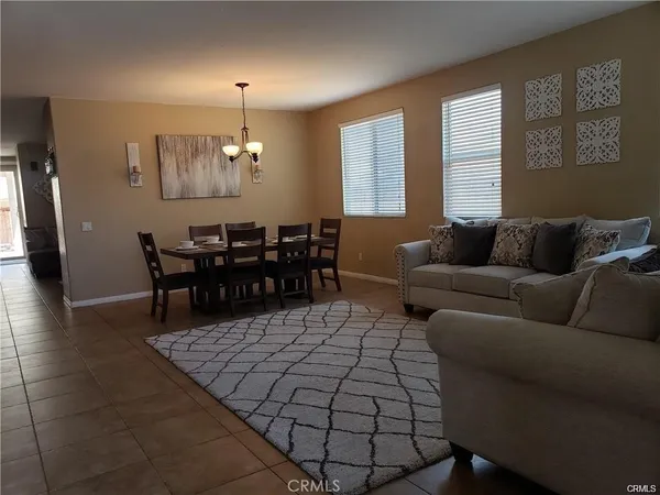 a living room with furniture a dining table and window