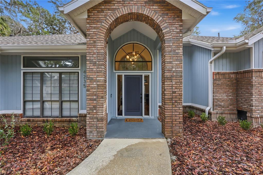 4235 Southwest 91st Drive Gainesville, FL 32608 - Photo 1 of 1 a front view of a house with garden