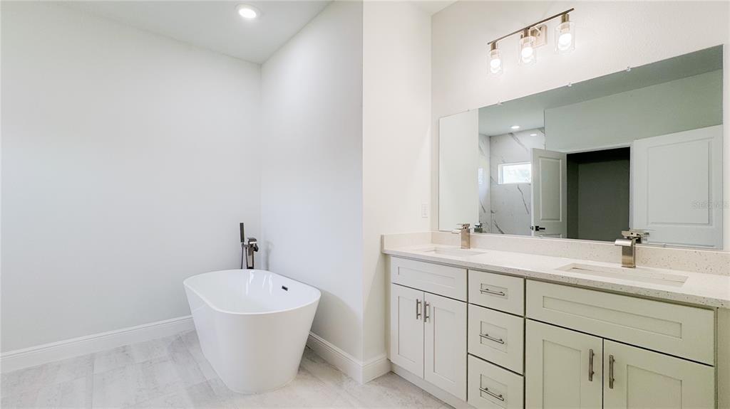 15625 Southwest 37th Circle Ocala, FL 34473 - Photo 25 of 27 a bathroom with a double vanity sink and mirror