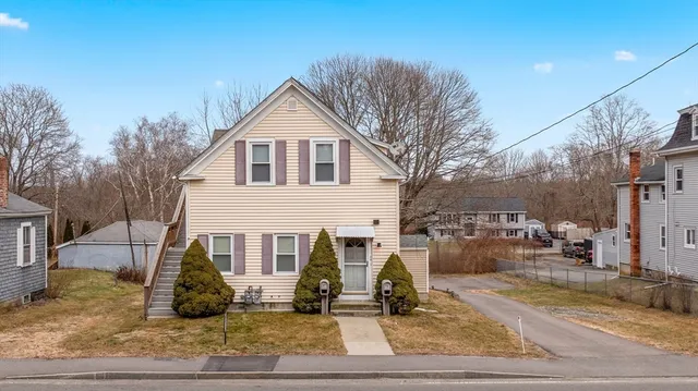 a kitchen with a sink a refrigerator and chairs