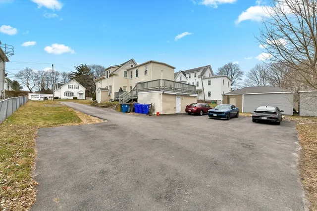 a view of a house with cars parked