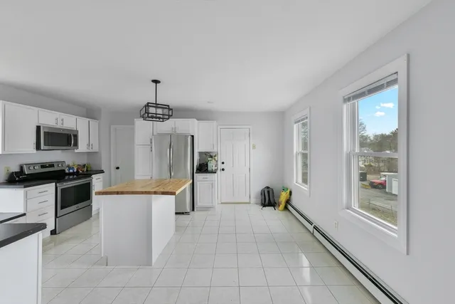 a kitchen with cabinets and stainless steel appliances
