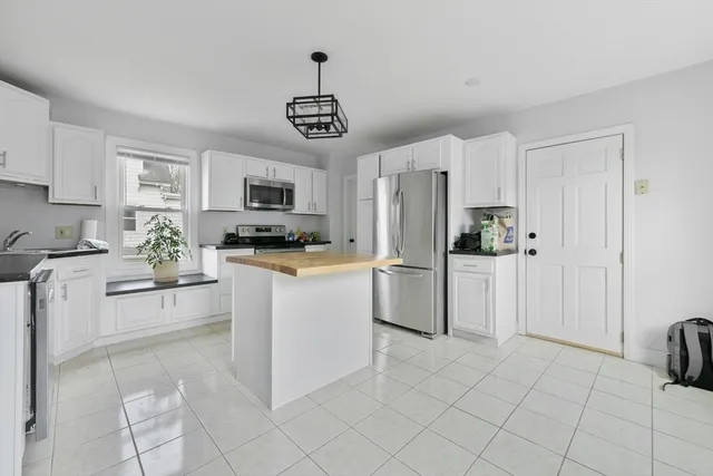 a kitchen with stainless steel appliances a refrigerator sink and cabinets