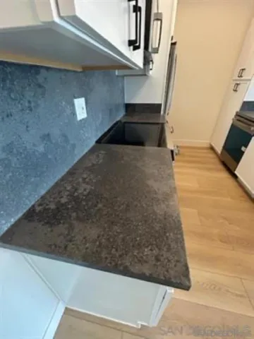 a view of kitchen with cabinets and wooden floor