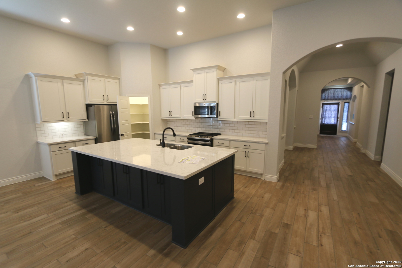 2965 Grove Way Seguin, TX 78155 - Photo 13 of 60 a kitchen with stainless steel appliances granite countertop a sink a stove and a refrigerator