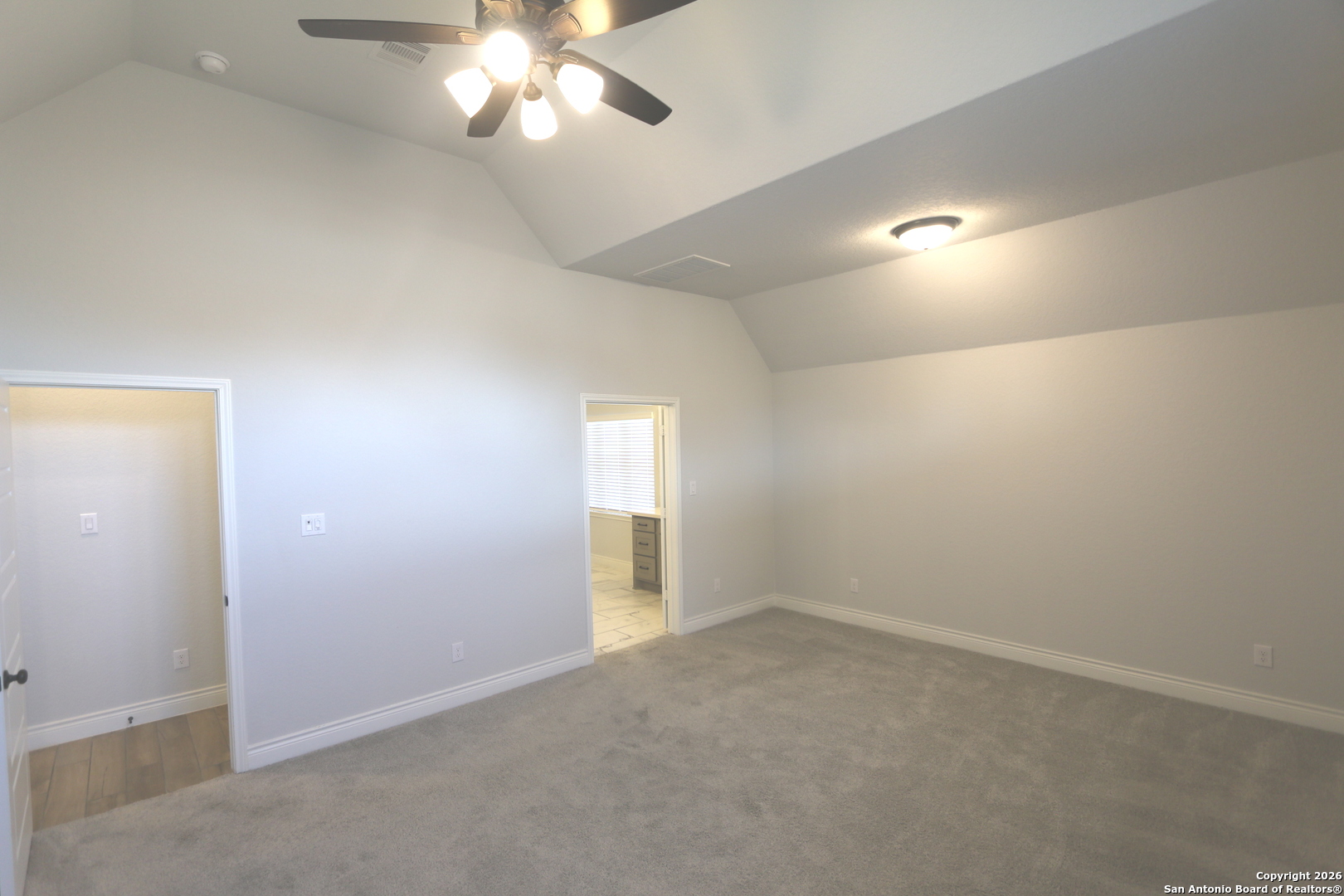 2965 Grove Way Seguin, TX 78155 - Photo 20 of 60 an empty room with a chandelier fan and windows
