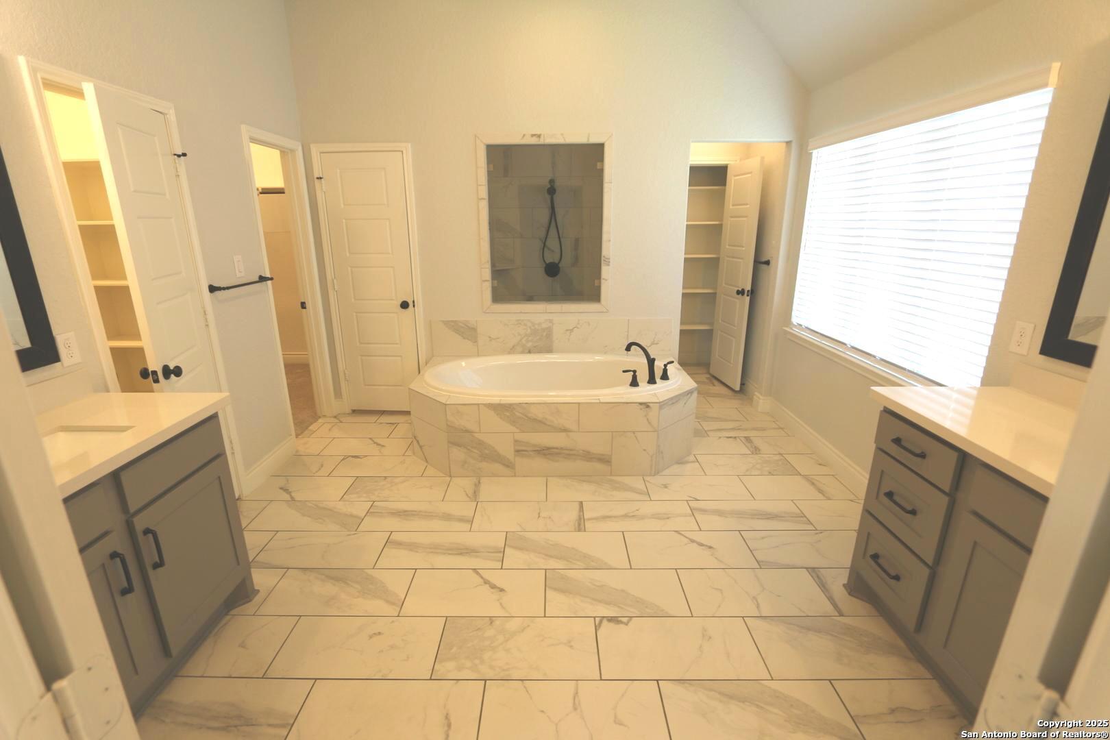 2965 Grove Way Seguin, TX 78155 - Photo 22 of 60 a spacious bathroom with a tub sink and a mirror