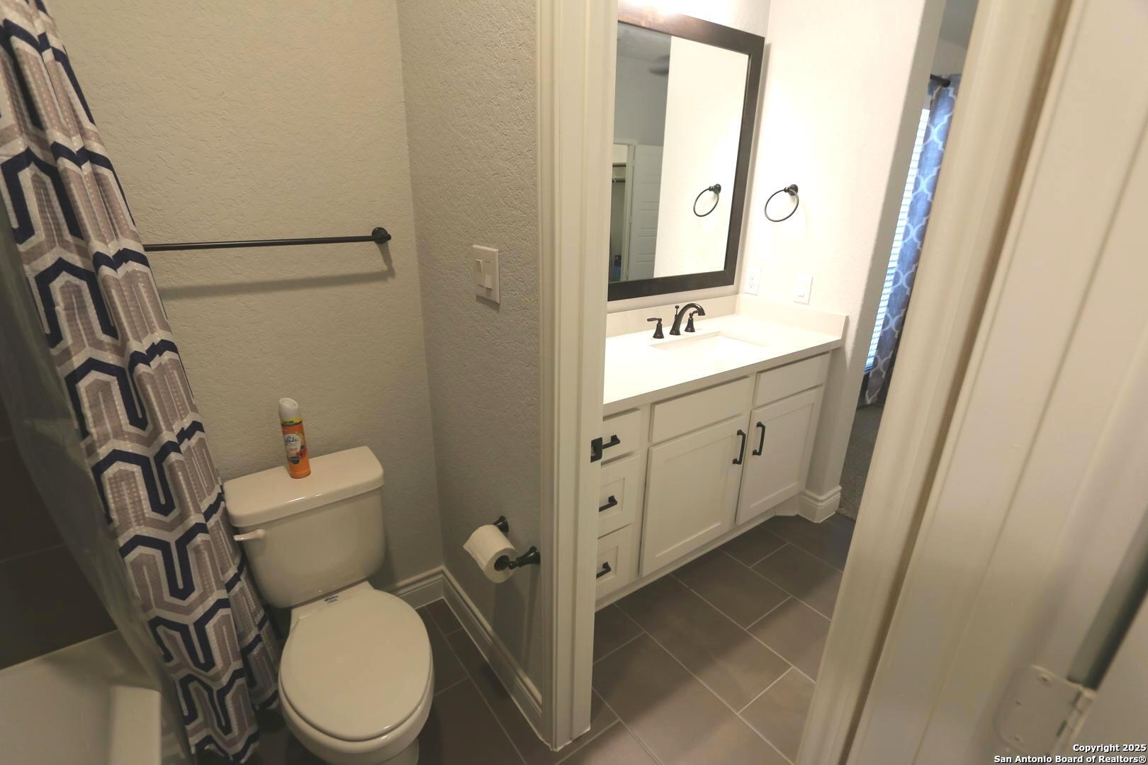 2965 Grove Way Seguin, TX 78155 - Photo 26 of 60 a bathroom with a toilet sink and mirror