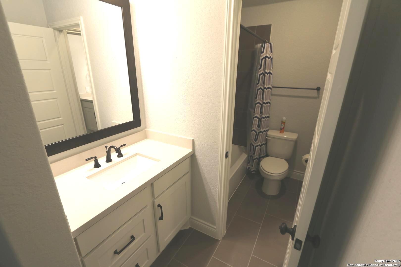 2965 Grove Way Seguin, TX 78155 - Photo 27 of 60 a bathroom with a sink a toilet and a mirror