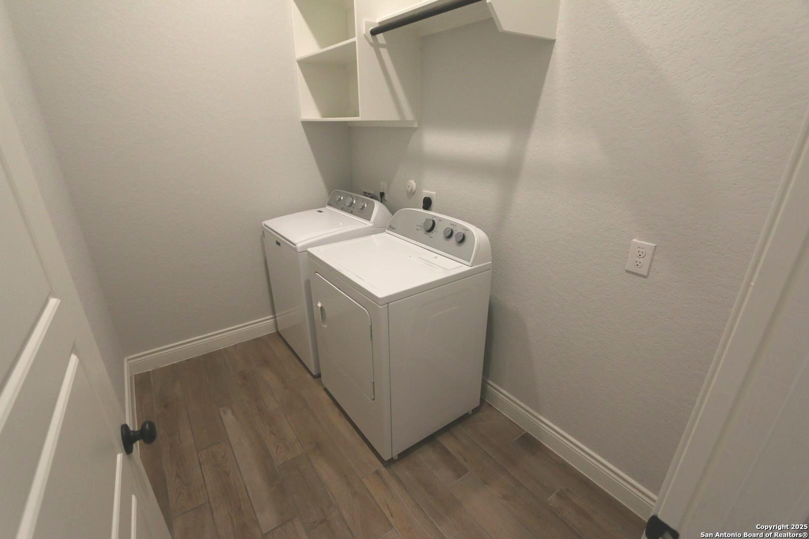 2965 Grove Way Seguin, TX 78155 - Photo 31 of 60 a utility room with wooden floor washer and dryer