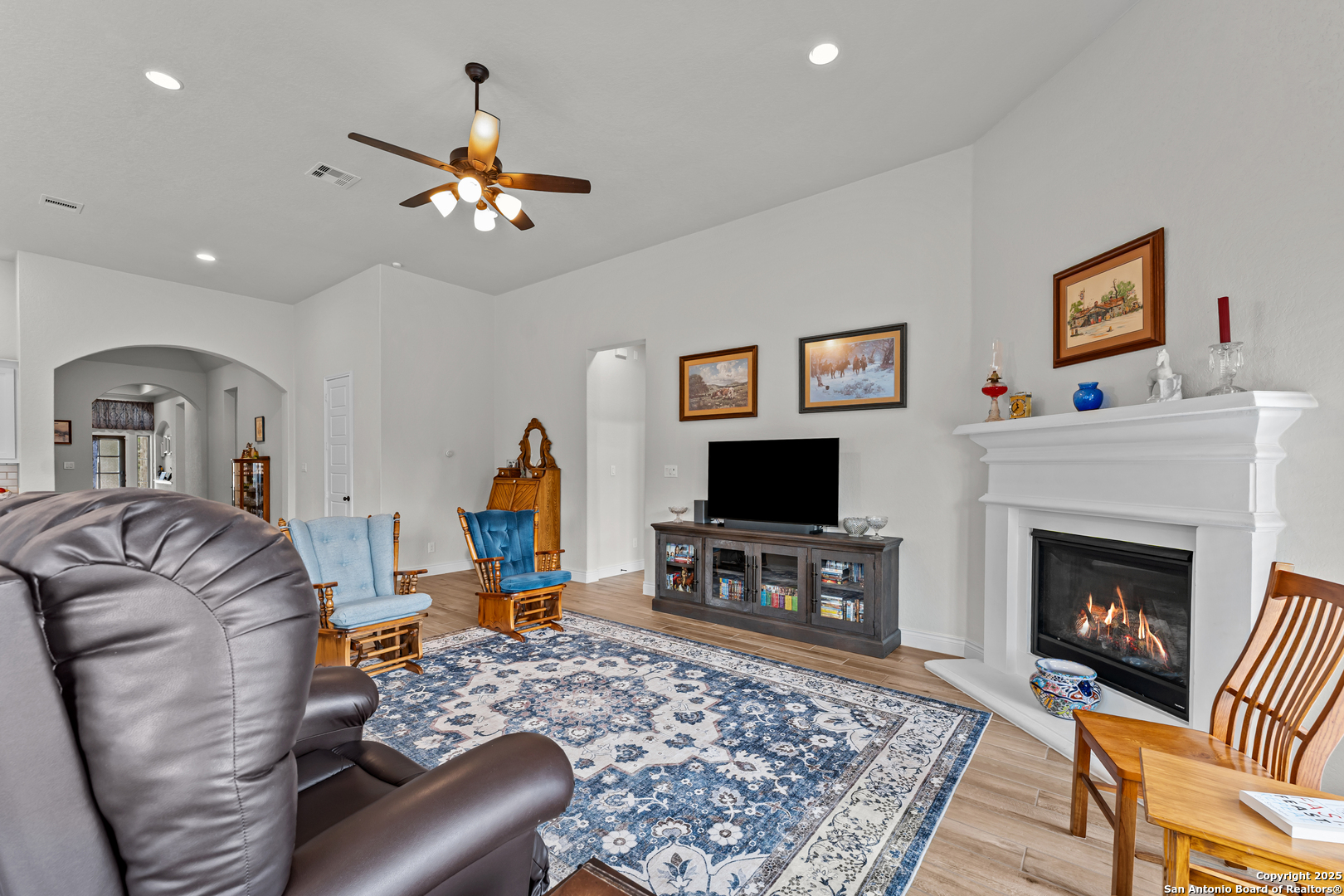 2965 Grove Way Seguin, TX 78155 - Photo 37 of 60 a living room with furniture a flat screen tv and a fireplace