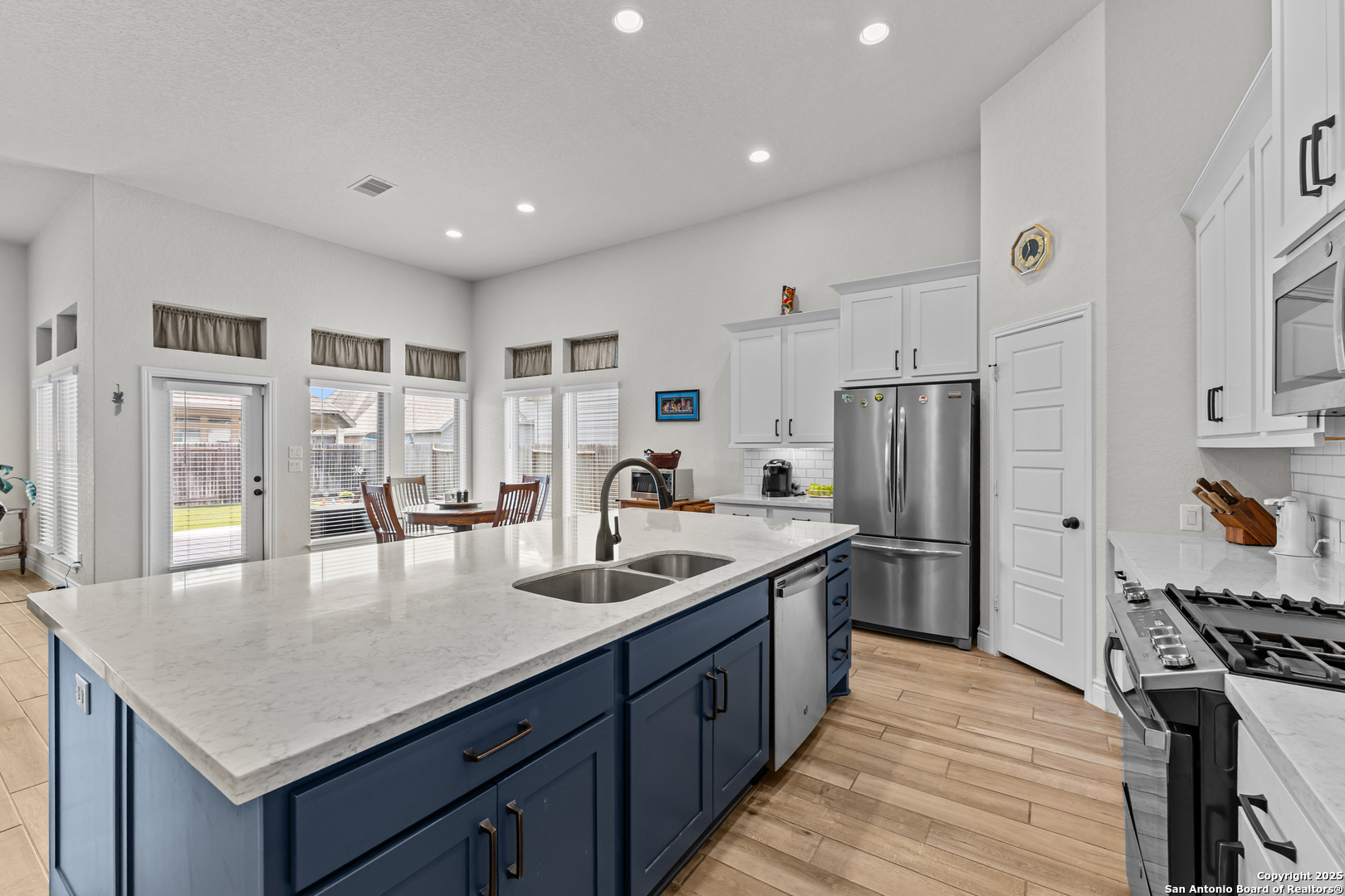 2965 Grove Way Seguin, TX 78155 - Photo 41 of 60 a kitchen with stainless steel appliances granite countertop a sink stove and refrigerator