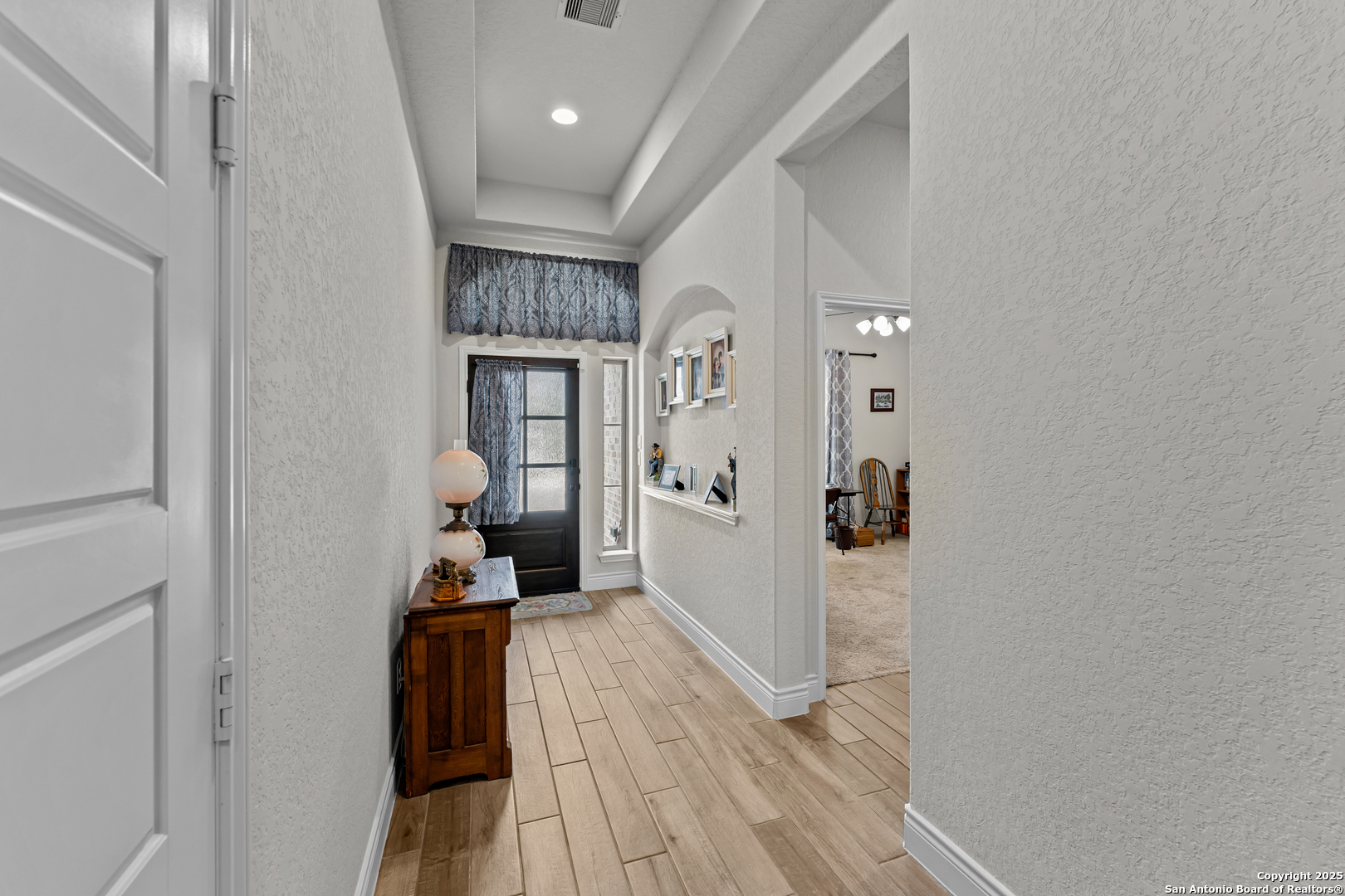 2965 Grove Way Seguin, TX 78155 - Photo 44 of 60 a view of a hallway with wooden floor and a living room