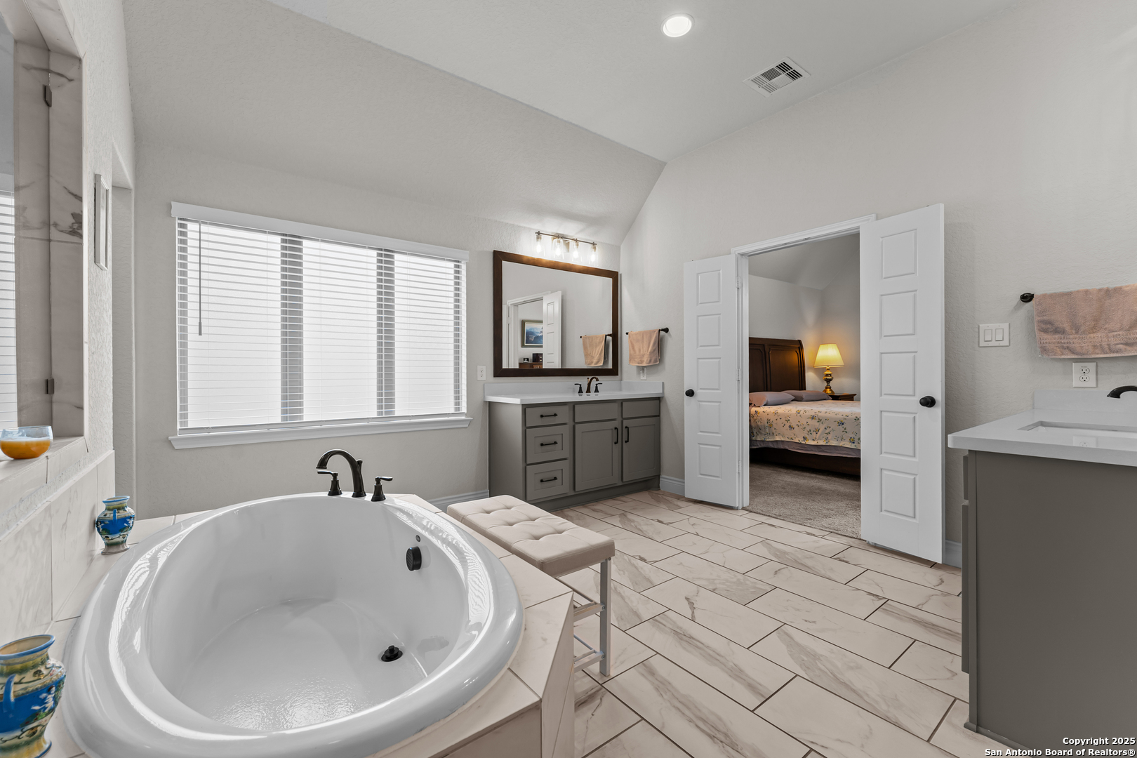 2965 Grove Way Seguin, TX 78155 - Photo 50 of 60 a en suite bathroom with a sink and mirror