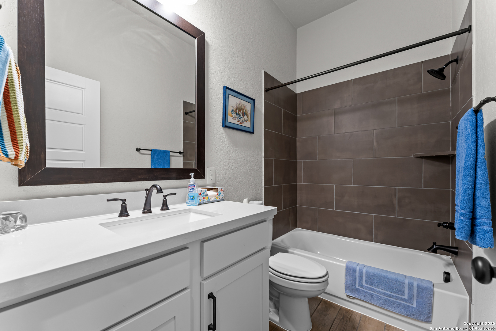 2965 Grove Way Seguin, TX 78155 - Photo 57 of 60 a bathroom with a sink a toilet a mirror and shower