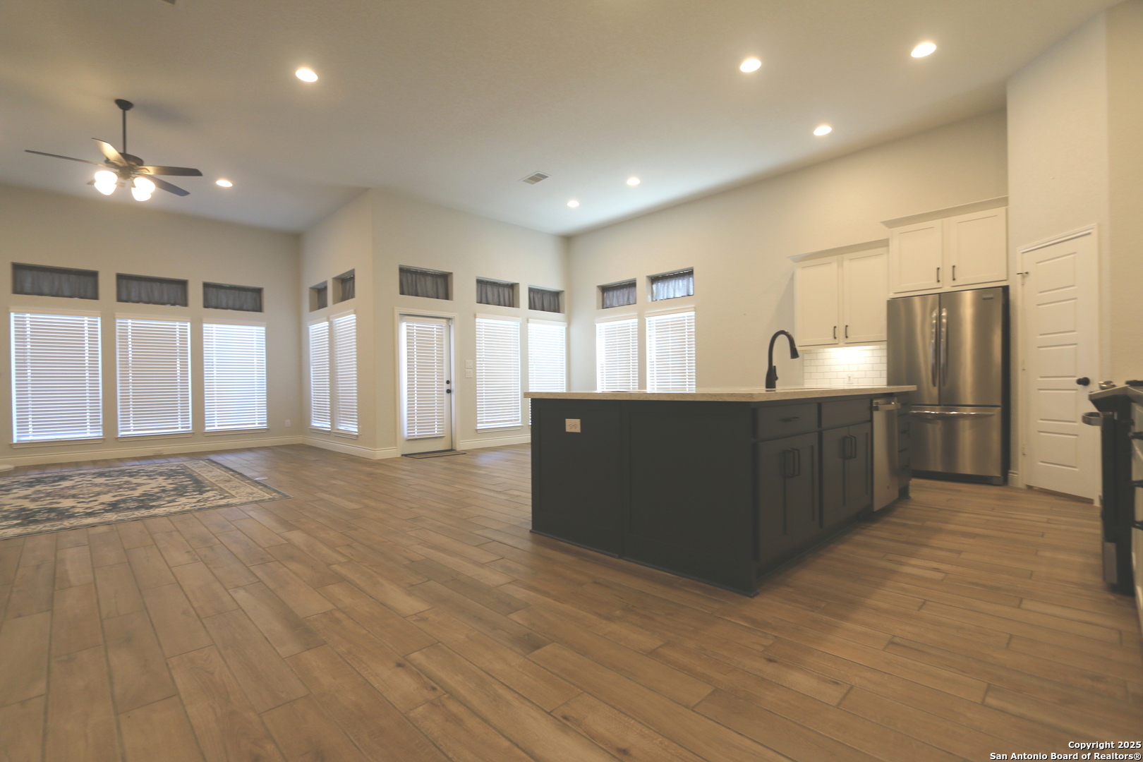 2965 Grove Way Seguin, TX 78155 - Photo 6 of 60 a kitchen with stainless steel appliances kitchen island granite countertop a refrigerator and a sink