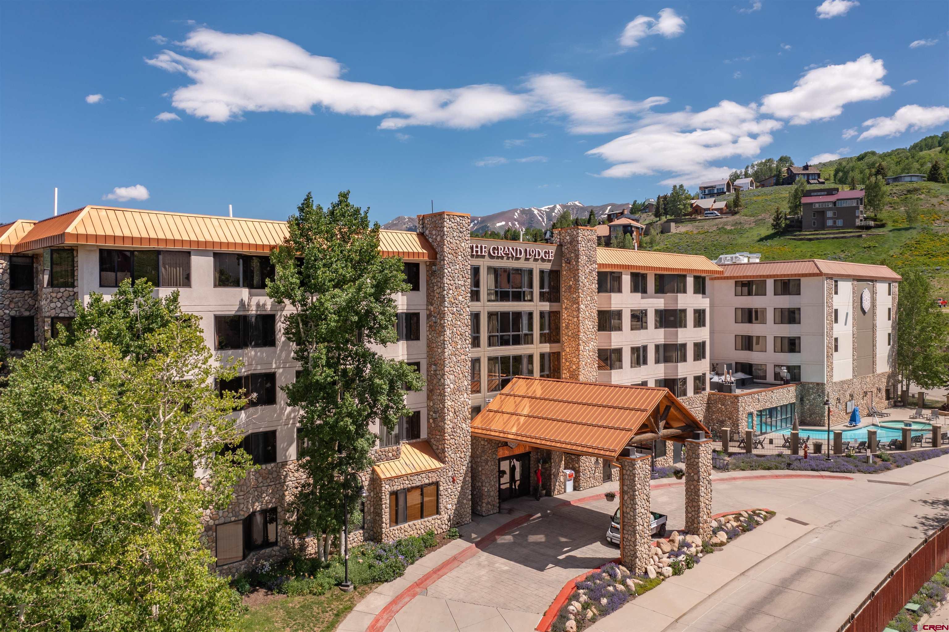 a front view of a building with a garden