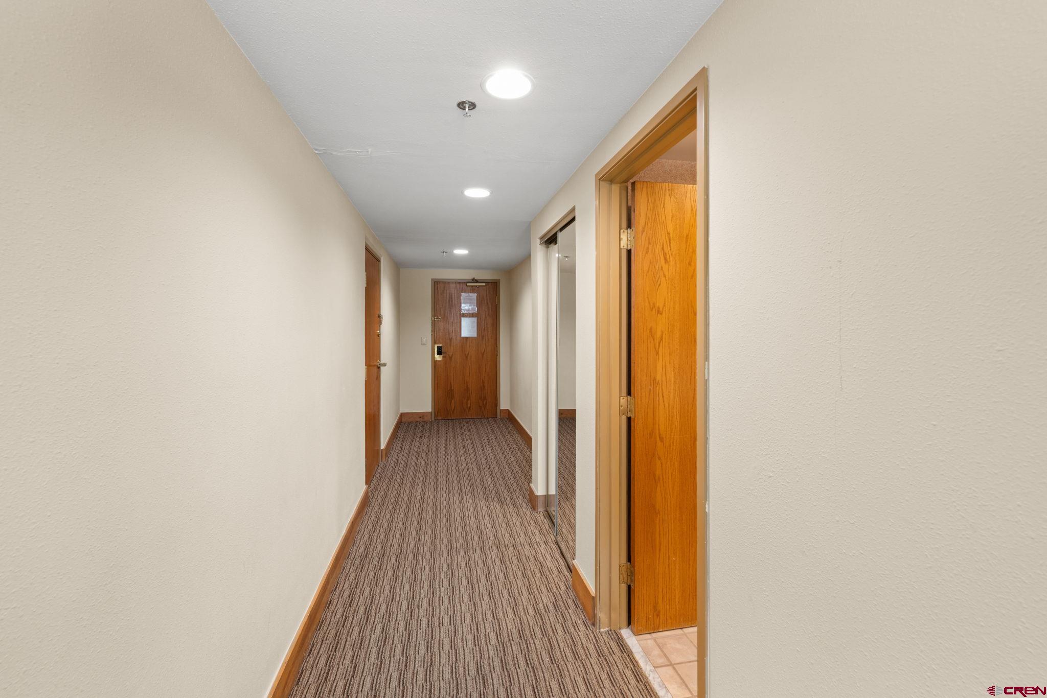 6 Emmons Road, Unit 452 & 454 Crested Butte, CO 81225 - Photo 16 of 38 a view of a hallway with wooden floor