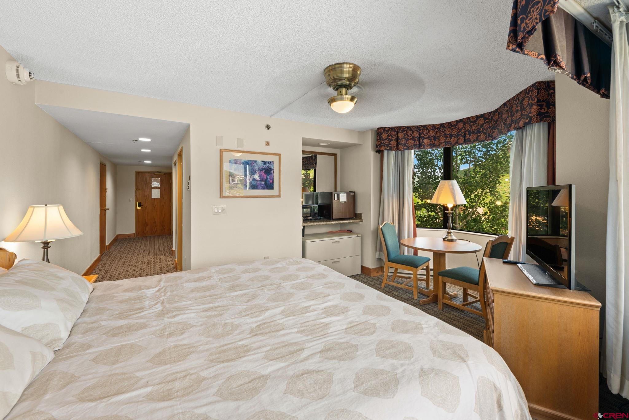 6 Emmons Road, Unit 452 & 454 Crested Butte, CO 81225 - Photo 17 of 38 a bedroom with a large bed and a large window