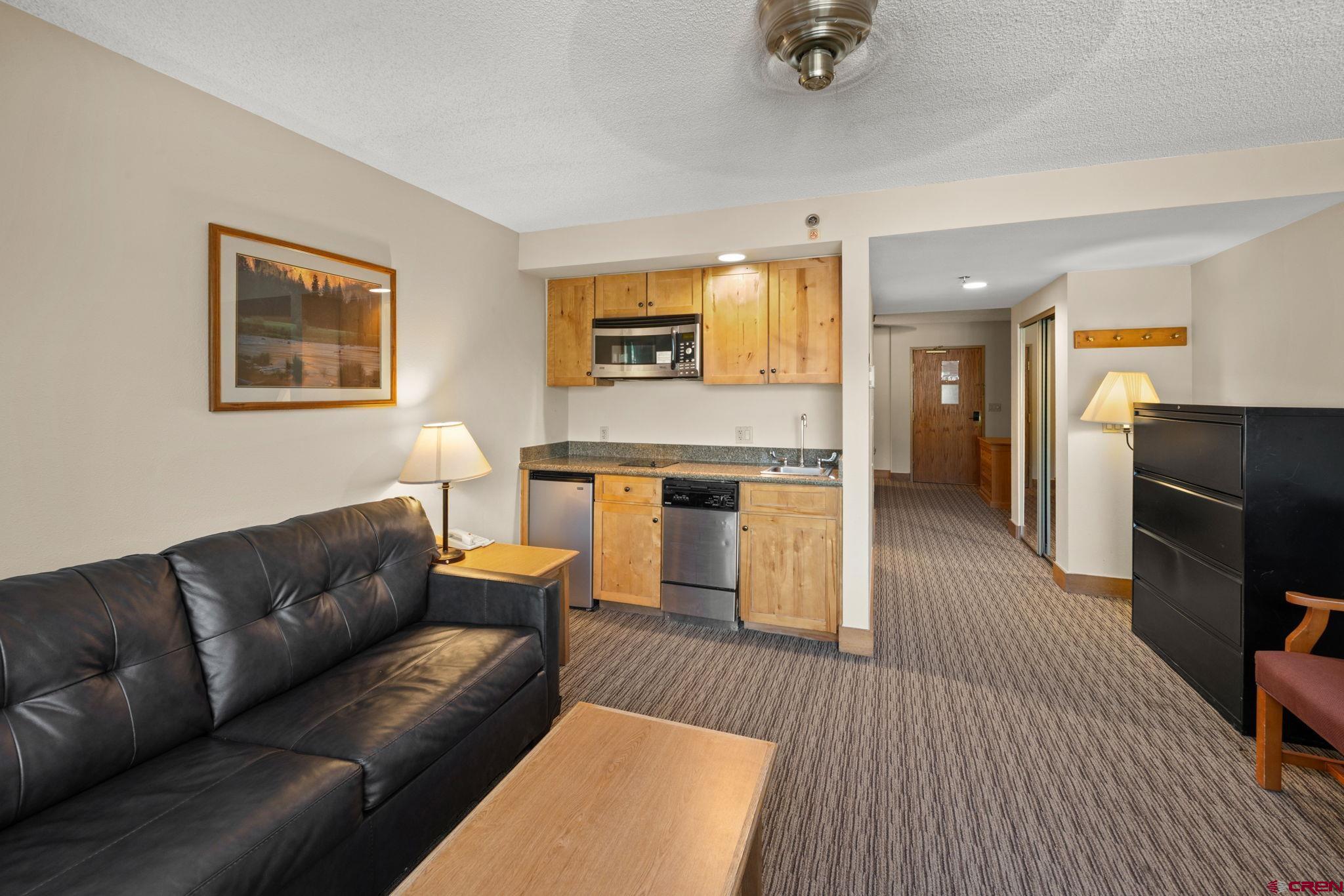 6 Emmons Road, Unit 452 & 454 Crested Butte, CO 81225 - Photo 3 of 38 a living room with furniture and a fireplace