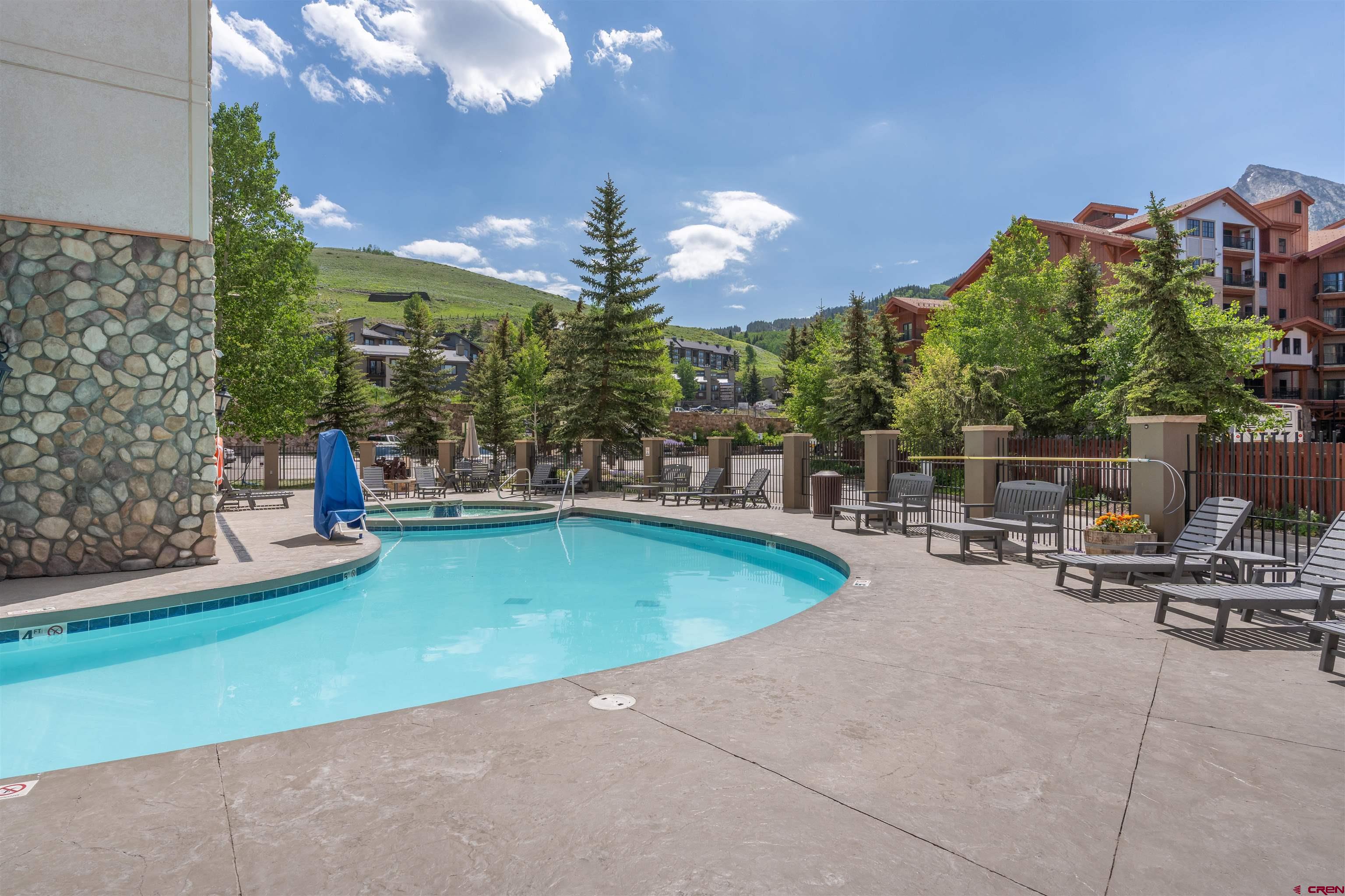6 Emmons Road, Unit 452 & 454 Crested Butte, CO 81225 - Photo 36 of 38 a view of a swimming pool with sitting area and slide