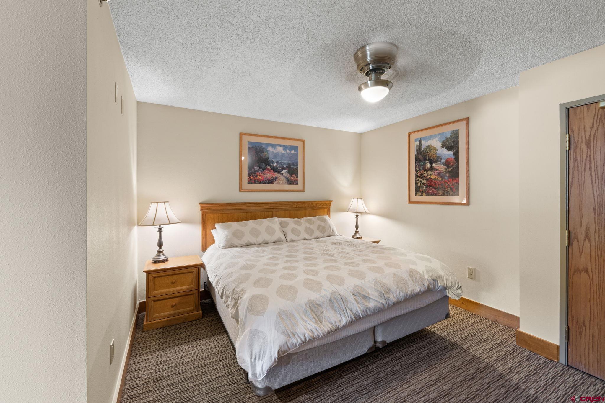 6 Emmons Road, Unit 452 & 454 Crested Butte, CO 81225 - Photo 6 of 38 a bedroom with a large bed and a chandelier