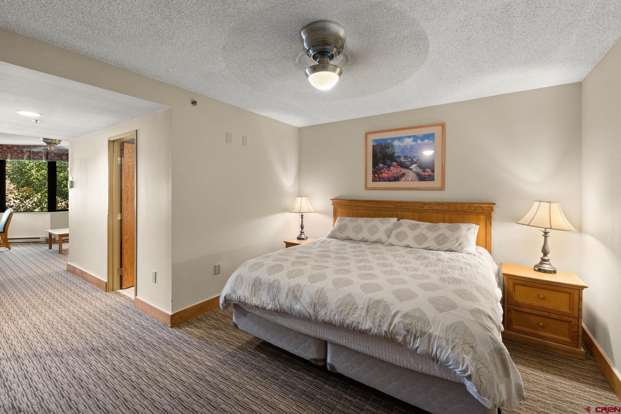 6 Emmons Road, Unit 452 & 454 Crested Butte, CO 81225 - Photo 7 of 38 a bedroom with a bed and a ceiling fan