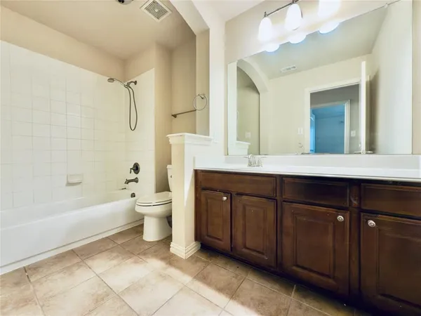 a bathroom with a sink toilet a mirror and shower