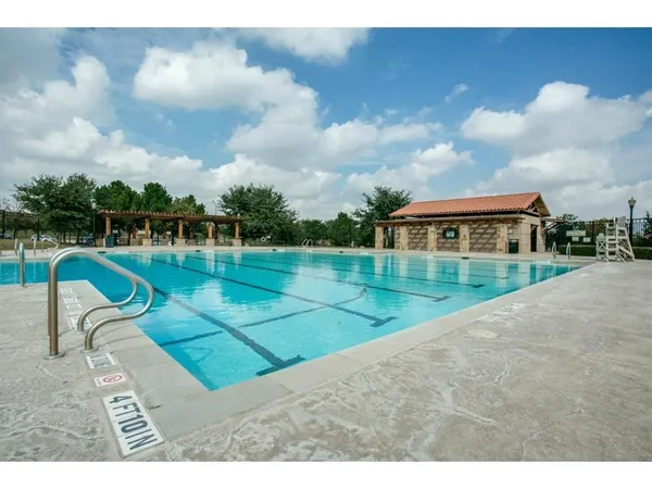 an aerial view of a house with yard swimming pool and outdoor seating