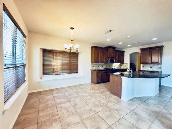 a kitchen with stainless steel appliances granite countertop a sink cabinets and stove top oven