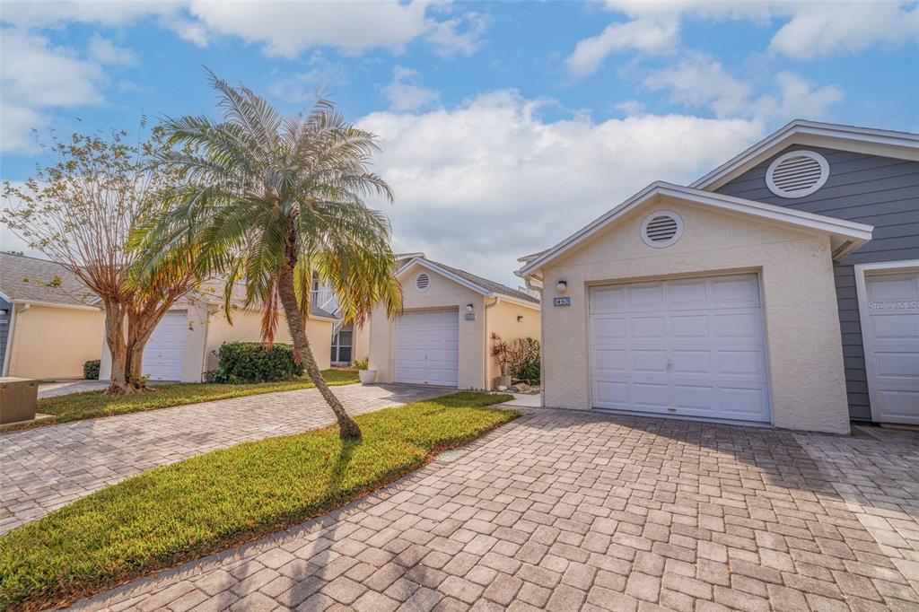 11680 Shipwatch Drive, Unit 1450 Largo, FL 33774 - Photo 1 of 1 a front view of a house with garden