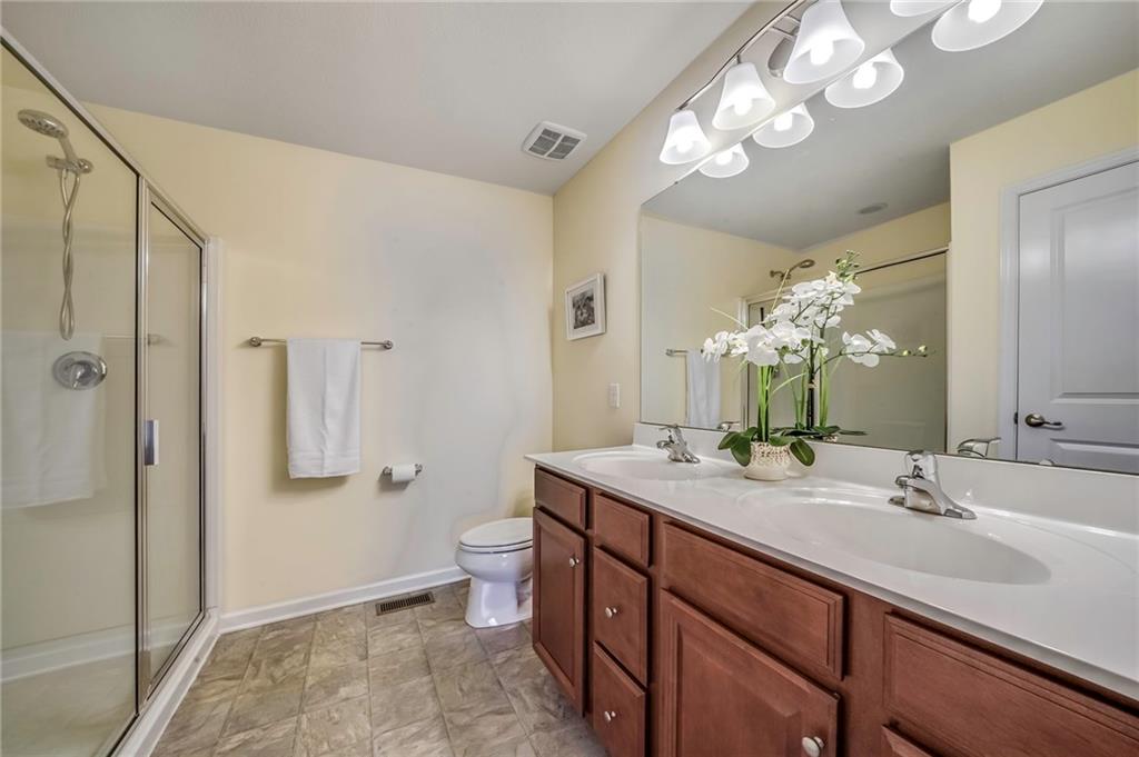171 Cimarron Drive Moon Township, PA 15108 - Photo 14 of 25 a spacious bathroom with a granite countertop sink a toilet and a large mirror
