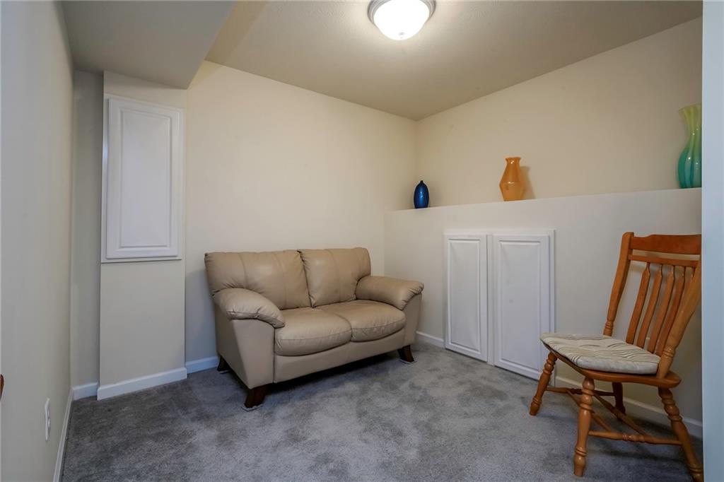 171 Cimarron Drive Moon Township, PA 15108 - Photo 22 of 25 a living room with furniture and a chair