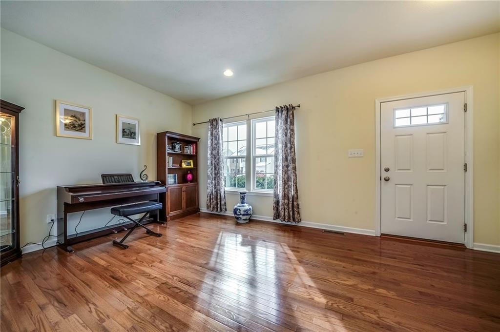 171 Cimarron Drive Moon Township, PA 15108 - Photo 3 of 25 a view of an empty room with wooden floor and a window