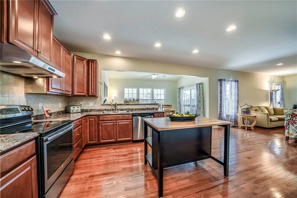171 Cimarron Drive Moon Township, PA 15108 - Photo 7 of 25 a kitchen with stainless steel appliances granite countertop wooden cabinets and sink