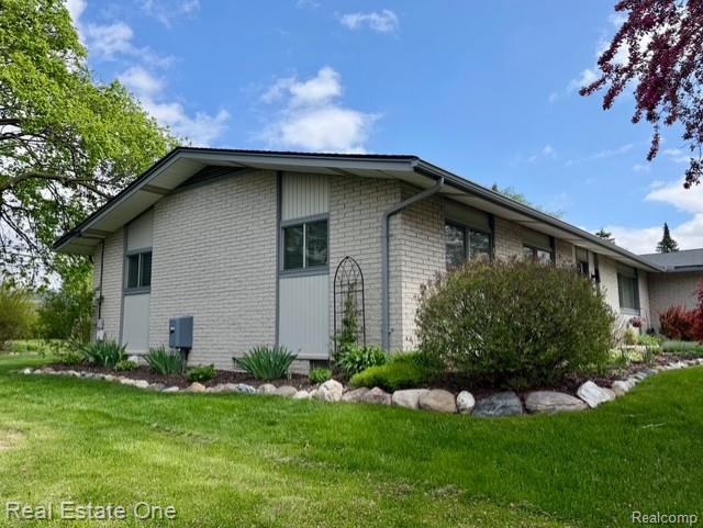 1115 Torpey Road Troy, MI 48083 - Photo 6 of 38 View of property exterior with brick siding and a lawn