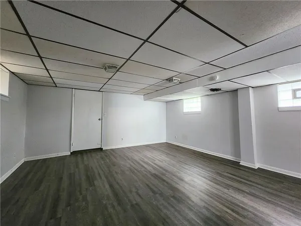 a view of a room with wooden floor