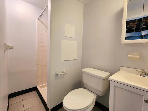 a white toilet sitting next to a bathroom sink