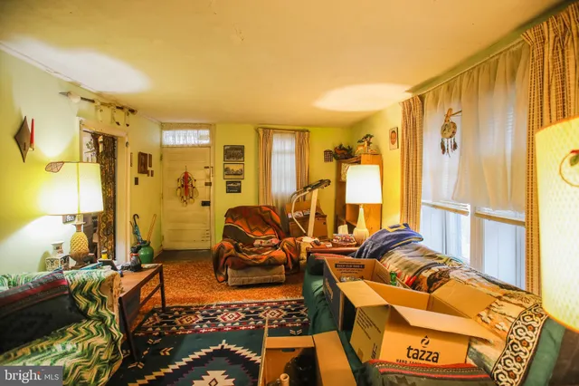 a view of a livingroom with furniture and floor to ceiling window