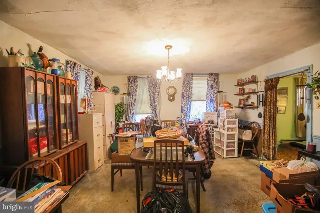 a view of a dining room with furniture and chandelier
