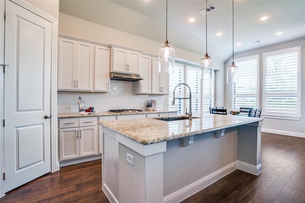 1621 Cotton Road Van Alstyne, TX 75495 - Photo 1 of 1 a kitchen with stainless steel appliances granite countertop a sink stove and white cabinets with wooden floor