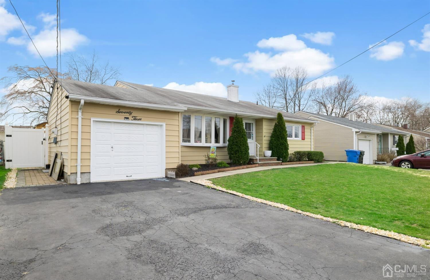 73 Westminster Road Colonia, NJ 07067 - Photo 3 of 36 a view of a house with a yard and garage