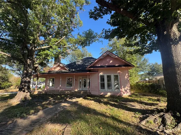 front view of a house with a tree