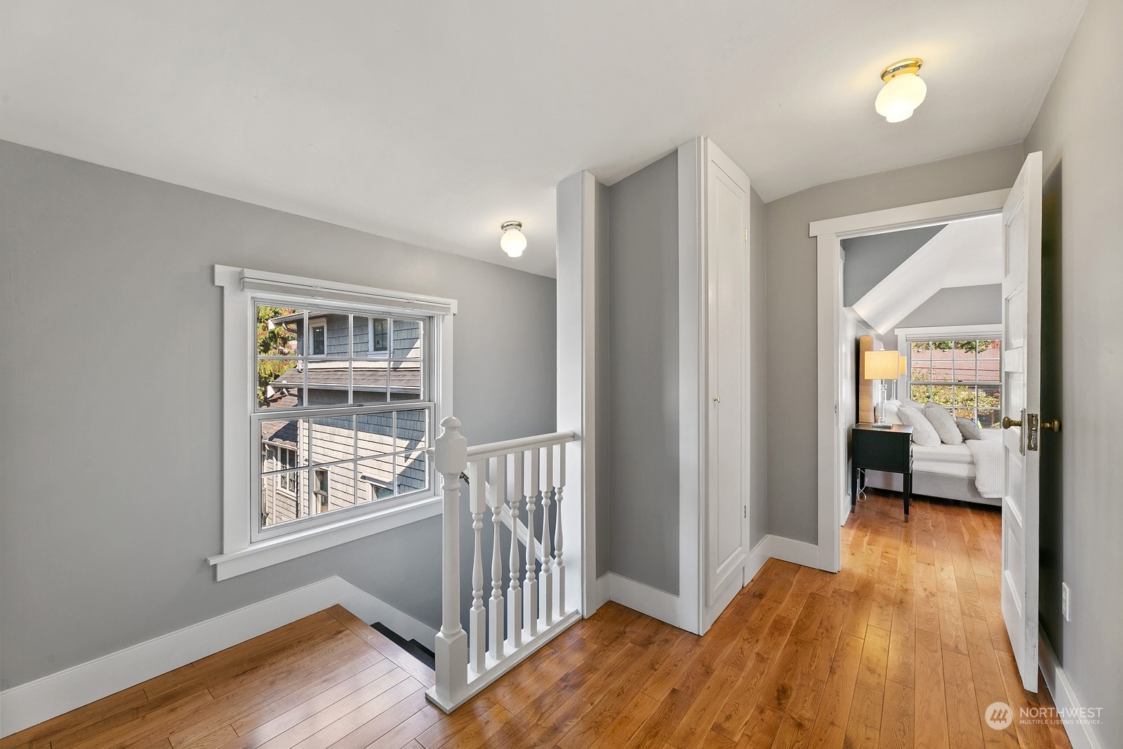 8053 12th Avenue Northeast Seattle, WA 98115 - Photo 16 of 27 a view of a hallway to a livingroom with wooden floor and windows