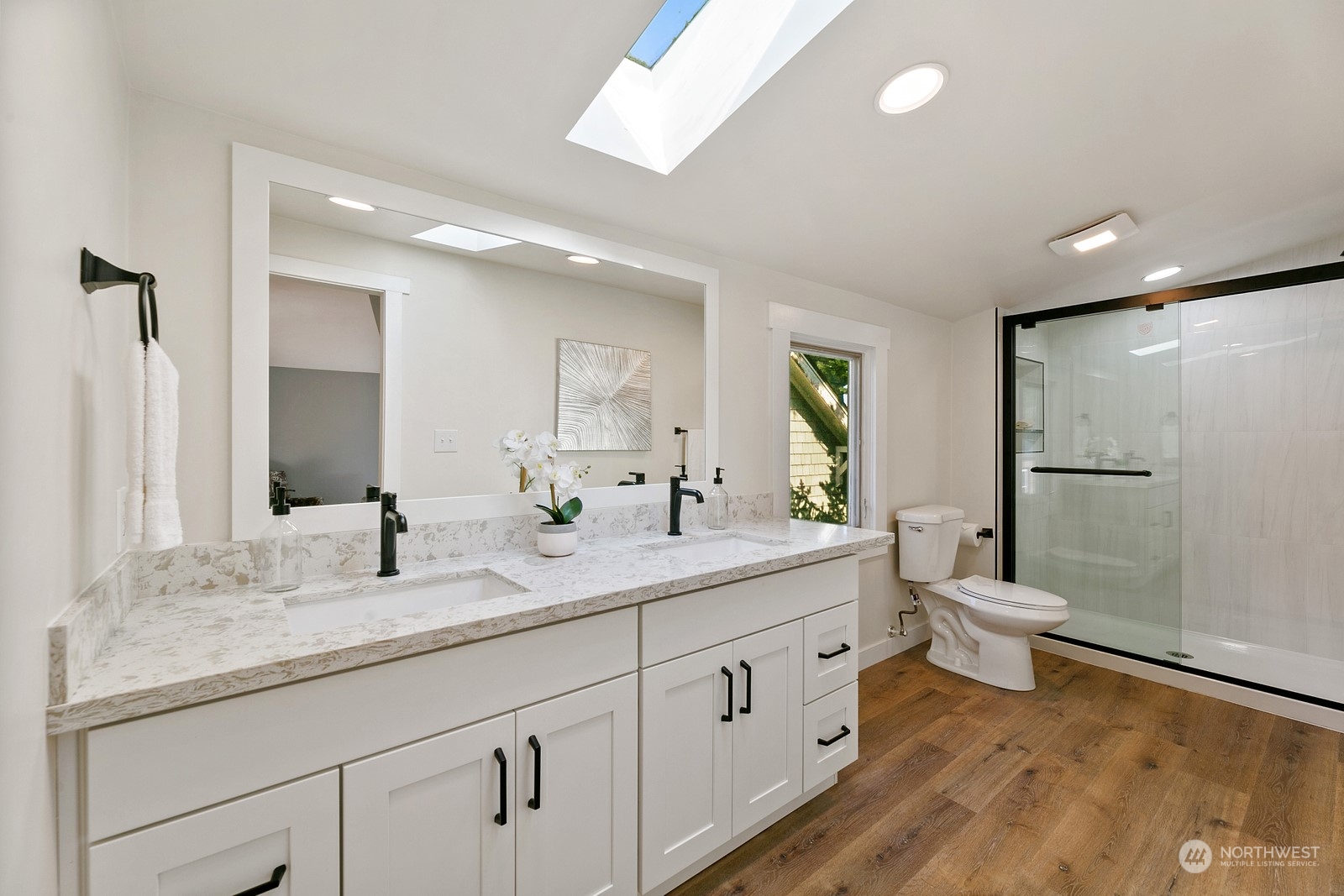 8053 12th Avenue Northeast Seattle, WA 98115 - Photo 21 of 27 a bathroom with a granite countertop toilet sink and mirror