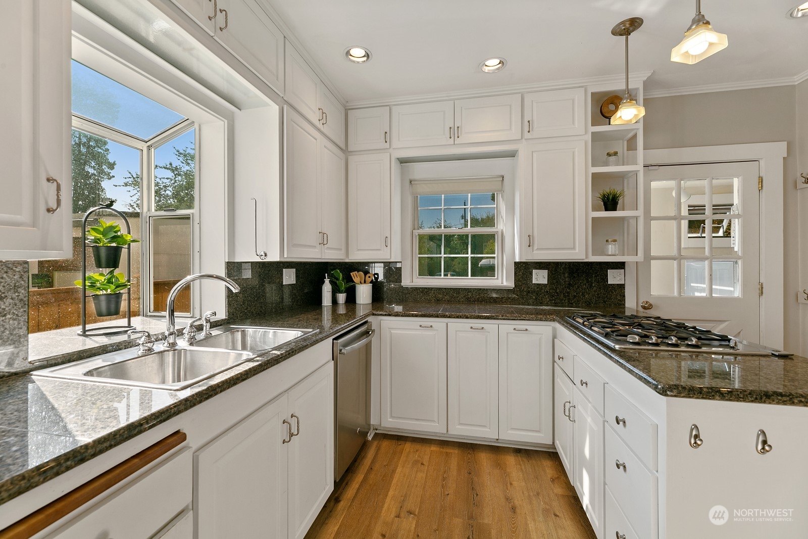 8053 12th Avenue Northeast Seattle, WA 98115 - Photo 9 of 27 a kitchen with stainless steel appliances granite countertop a sink stove and cabinets