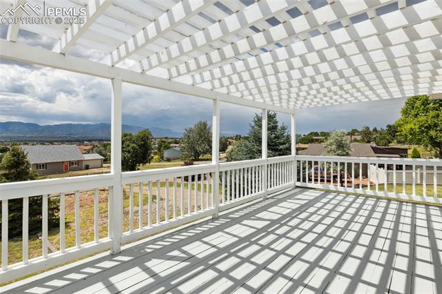 10925 Double D Road Fountain, CO 80817 - Photo 31 of 33 Deck featuring a mountain view and a pergola