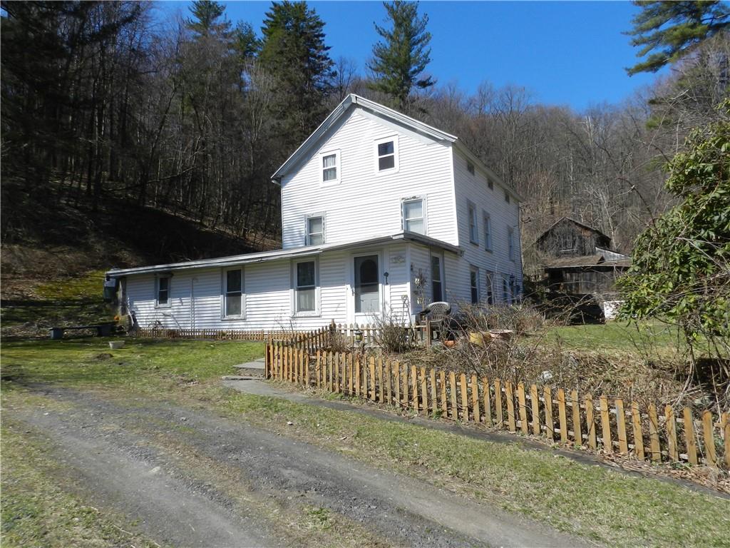 a front view of house with yard and trees