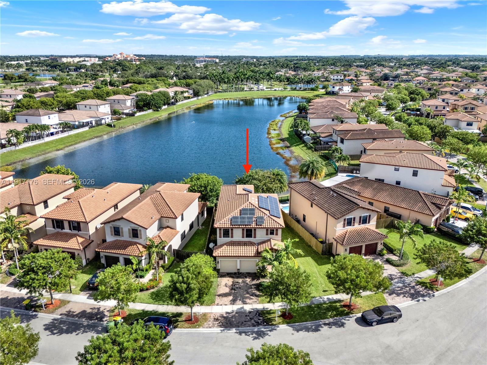 an aerial view of a house with a lake view
